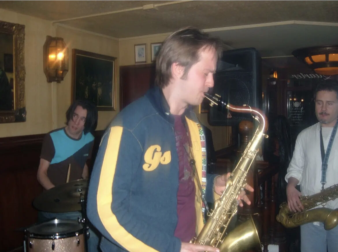 An early photograph of Remco Keijzer performing tenor saxophone in a club